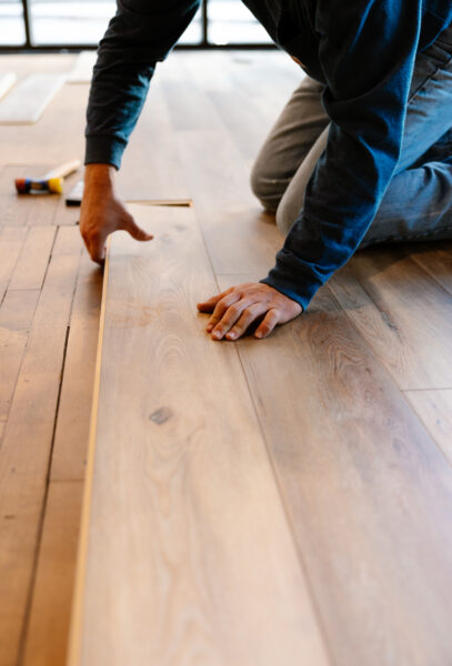 Person laying wooden floor planks